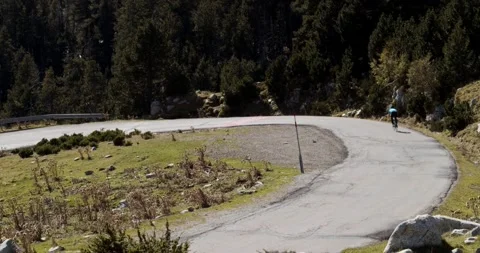 Road cyclist descends a mountain at full speed Stock Footage 140901907