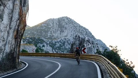 Road cyclist in mountains. Stock Photos