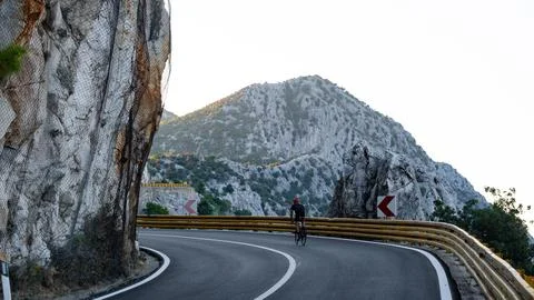 Road cyclist in mountains. Stock Photos