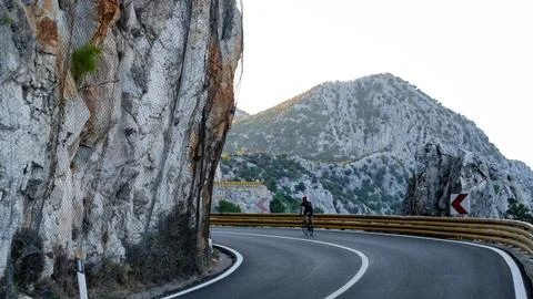 Road cyclist in mountains. Stock Photos