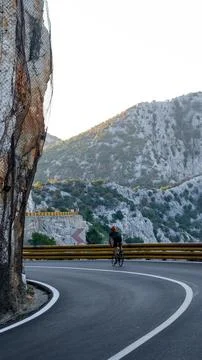 Road cyclist in mountains. Stock Photos