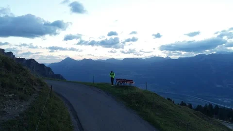 Road Cyclist Preparing for Downhill Ride at Dawn Stock Footage 344584792