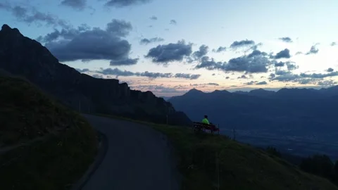 Road Cyclist Viewing Winding Mountain Road from Above Stock Footage 344584679