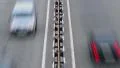 Road divider cars passing by, city dense traffic daytime HD Footage
