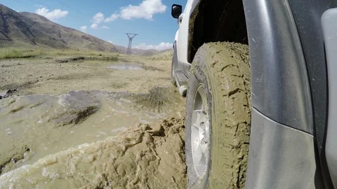 Off-road driving through mud on mountainous road Stock Footage 87419011
