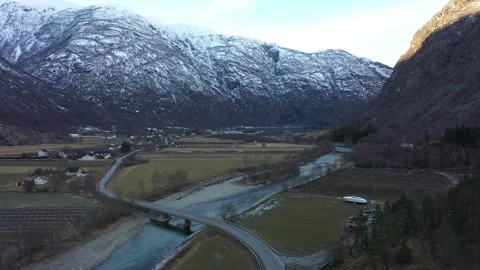 Road E16 passing on bridge over Laerdal river - Ascending aerial after Stock Footage 182349290