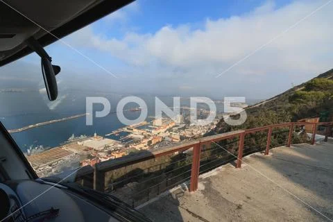 Road on the edge of cliff drive to The Rock Gibraltar harbor Stock Photos