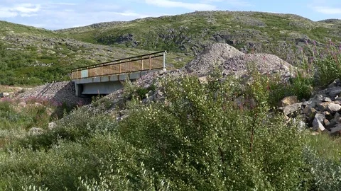 Road embankment and small bridge over a Creek in a wooded area. Stock-Footage 84174591