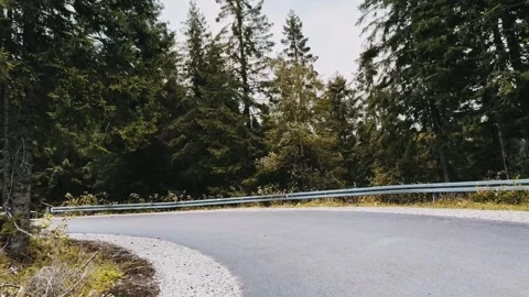 Road in the fall forest against the background of mountains. Storm in the woods Stock Footage 254605901