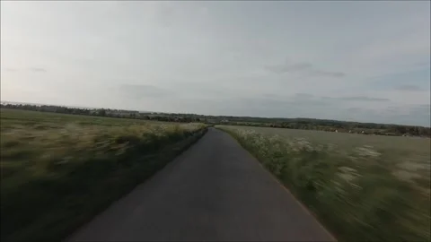 A road with a field in the background Stock Footage 298255583
