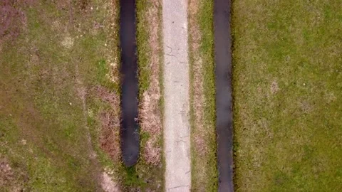 Road in a field with streams beside creative Stock Footage 150974600