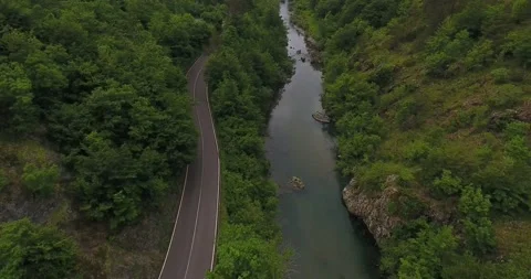 The road follows the course of the river Stock Footage 156175176