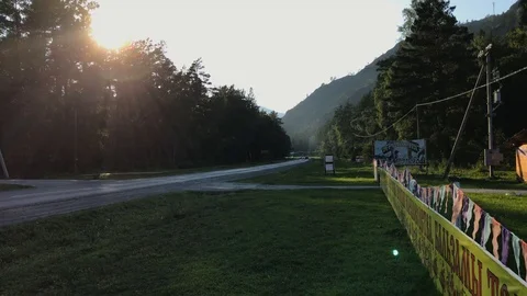 A road by a forest and mountains Stock Footage 92670840