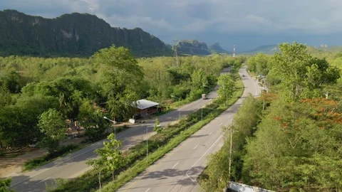 The road in the forest has beautiful mountains. Stock Footage 132736079