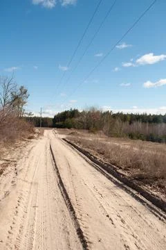 The road in the forest: there is a rough sandy road. Stock Photos