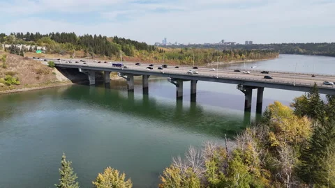 A road full of vehicles crosses a river Stock Footage 317473981