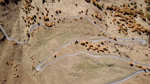 Road to the Gavia mountain pass in Italy. Aerial view of the mountain bends Stock Footage