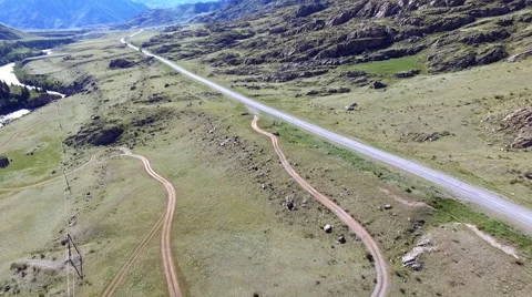 The road goes through the plain between the mountains Stock-Footage 67834851