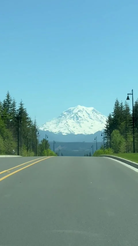 Road going to the Mount Rainier with the snow on the top car view Stock Footage 277480527