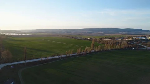 Road in green fields at sunset 動画素材 105481235