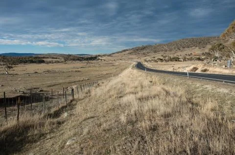 Road heading into the distance between two fields in rural australia Stock Photos
