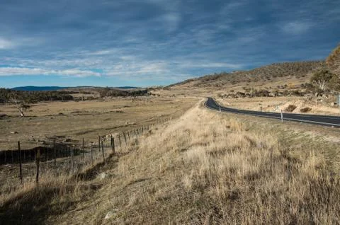Road heading into the distance between two fields in rural australia Stock Photos