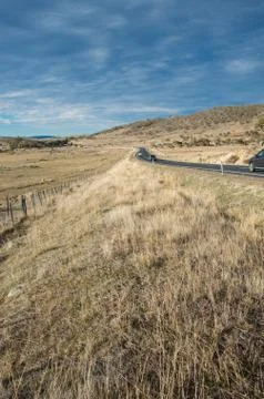 Road heading into the distance between two fields in rural australia Stock Photos