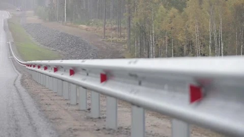 Road, highway,  forest on the sides, cloudy,  asphalt, barrier , reflectors Stock Footage 303406572