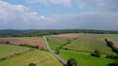 Road on a hill next to the fields Stock Footage 171388751