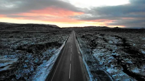 Road in Iceland surrounded by lava fields covered with snow Stock Footage 102856674