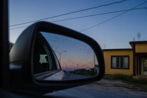 Road from the inside of a car and the reflection of the rear-view mirror of t Stock Photos