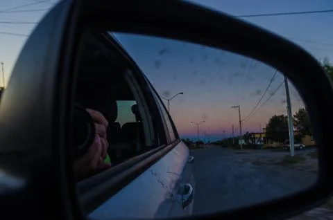 Road from the inside of a car and the reflection of the rear-view mirror of t Stock Photos