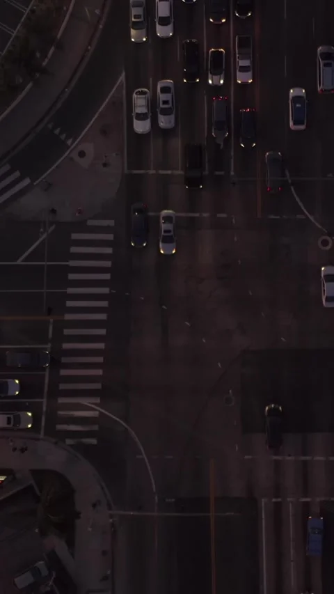 Road intersection at dusk with car traffic passing and parking lot in Los Angele Stock-Footage 337411405