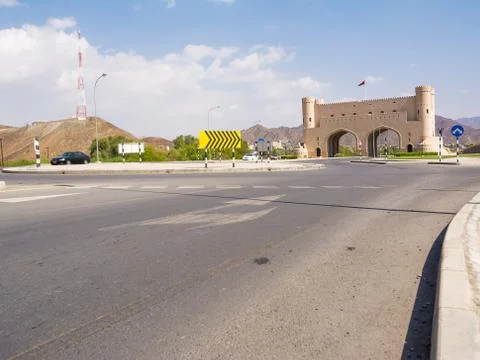 Road intersection with entry portal and cars in transit on any day Stock Photos