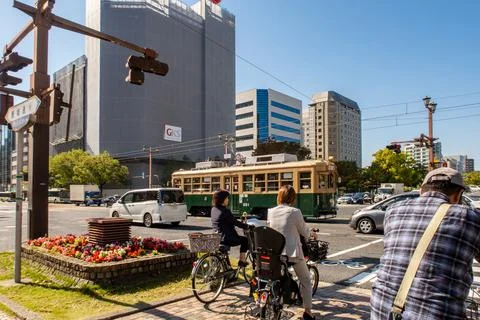 Road intersection in Hiroshima with famous old green tram car no 651. Fotos de archivo