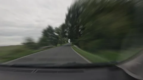 Road journey filmed through a windshield as time lapse with dark clouds app.. Stock Footage 345800328