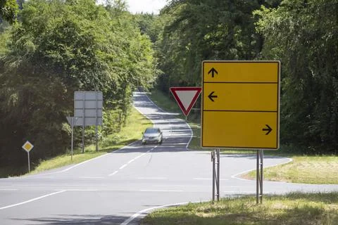 Road junction with empty information signs and traffic signs Stock Photos