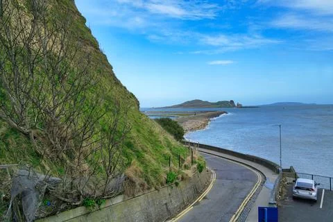 Road leading down from the Howth Head cliffs to the harbor Stock Photos