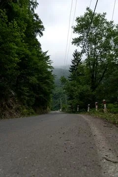 The road leading down. Mountains on the background, cloudy sky, Georgia Stock Photos