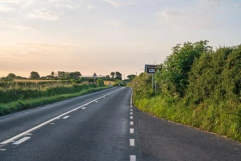 Road Leading Into Looe Cornwall At Gentle Sunrise With Countryside Views Stock Photos