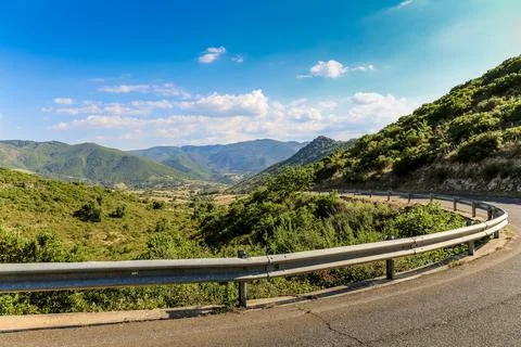A road with a long, curvy section of it on the island of Sardinia in Italy Foto stock