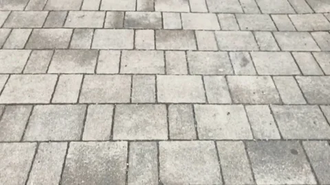 The road made of grey stone bricks. Concrete blocks pavement. Video stock 116233625