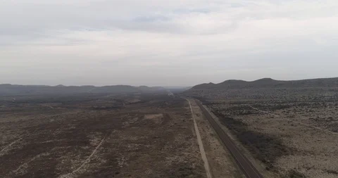 Road in Marathon, Texas with mountainous, desolate environment drone aerial 4K Stock Footage 111316319