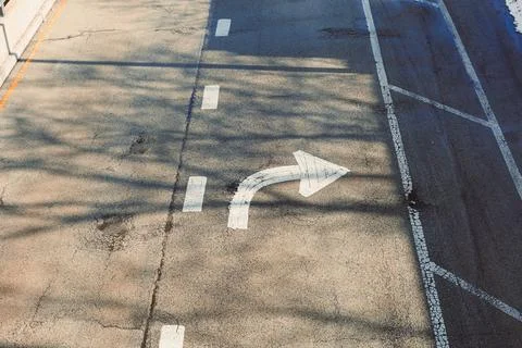 Road marked with a right turn arrow shows clear directions for drivers. Shado Stock Photos