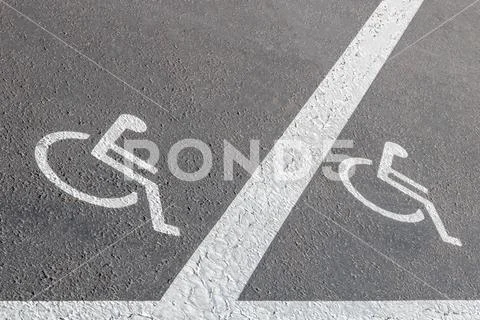 Road marking, road signs reserved parking for persons with reduced mobility Stock Photos