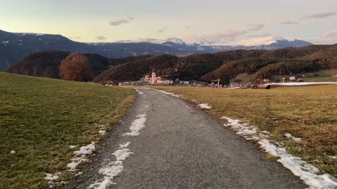 Road on the meadow in front of mountains Stock Footage 232678664