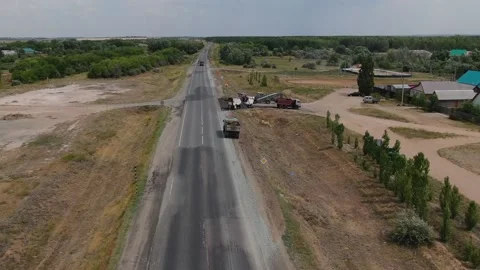 A road milling machine cuts old asphalt and loads it into a dump truck. Stock Footage 145466074