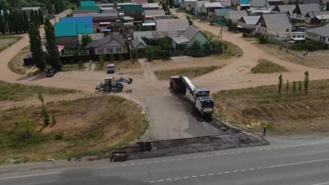 A road milling machine cuts old asphalt and loads it into a dump truck. Stock Footage 145466085