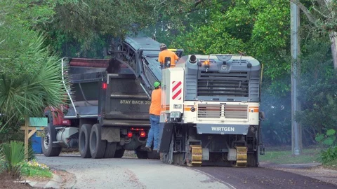 Road milling - process of stripping the top layer off an old road Stock Footage 127644154