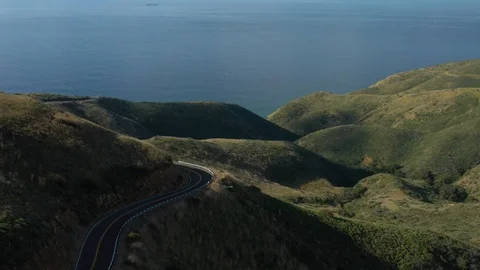 Road by a mountain hill ocean Stock Footage 127582190